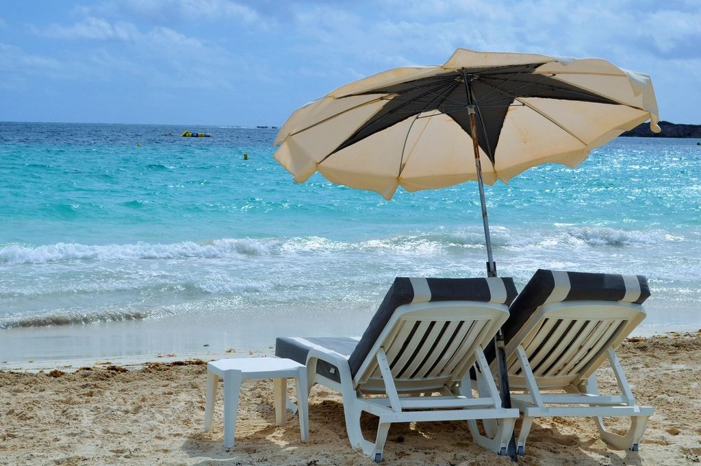 Sun loungers and a parasol beside the pool