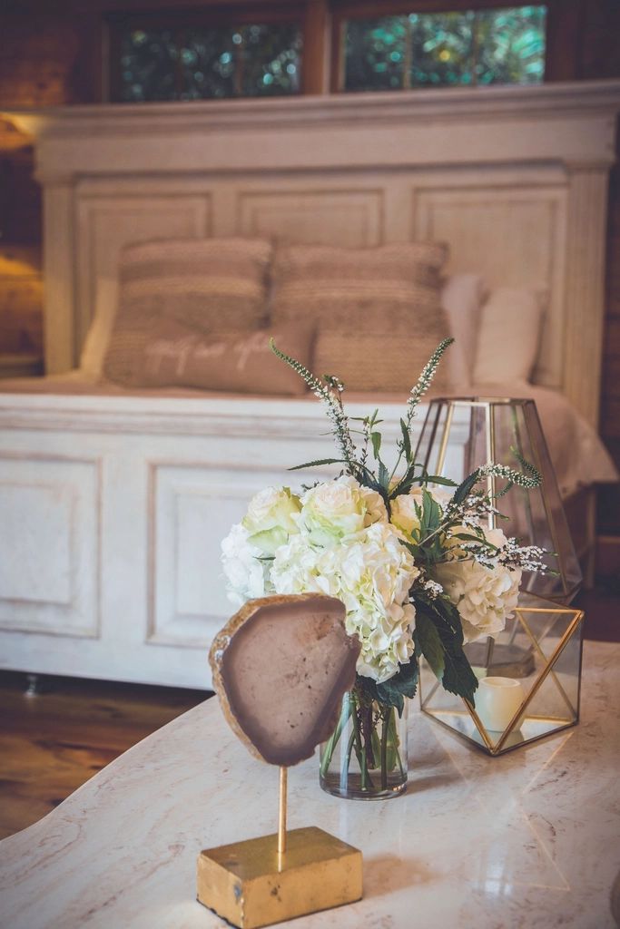 A guest room with a large bed and soft lighting